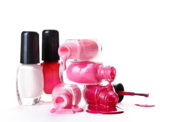 Open bottles with bright nail polish isolated on white clipart