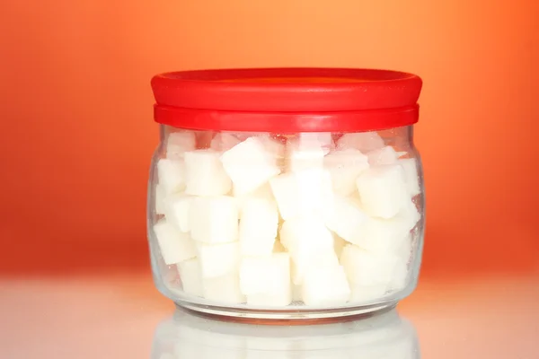 Jar with a white lump sugar on bright colorful background — Stock Photo, Image