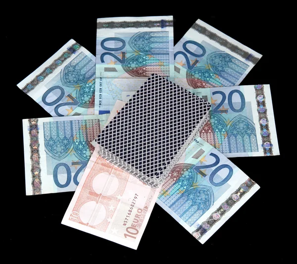 Euro és egy pakli kártya elszigetelt fekete — Stock Fotó