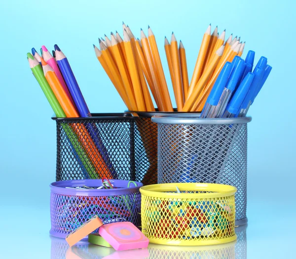 Color holders for office supplies with them on bright background — Stock Photo, Image
