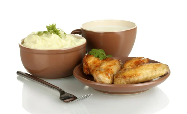 Mashed potato with parsley in the bowl and roasted chicken wings in the plate and cup with milk isolated on white — Stock Photo, Image