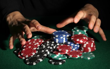 Poker chips and hands above it on green table clipart