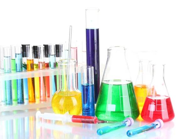 Diferentes cristalería de laboratorio con líquido de color aislado en blanco —  Fotos de Stock