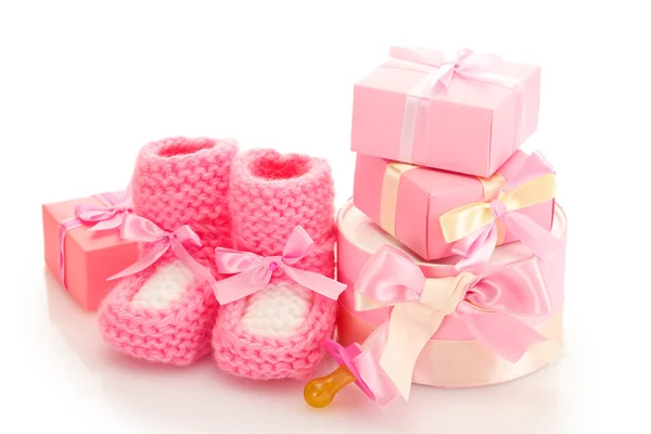 Rosa Babystiefel, Schnuller und Geschenke isoliert auf weiß — Stockfoto