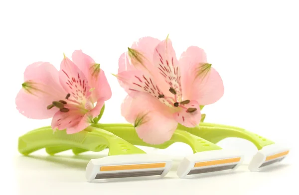 Woman safety shavers and flowers isolated on white — Stock Photo, Image