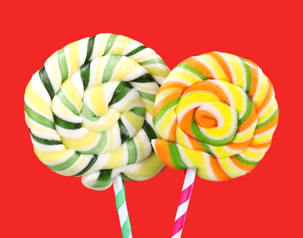 Colorful lollipops on red background — Stock Photo, Image