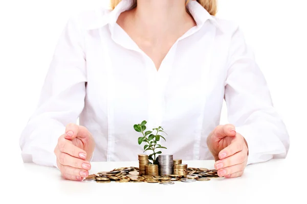 Woman hands with coins and plant isolated on white — Stock Photo, Image