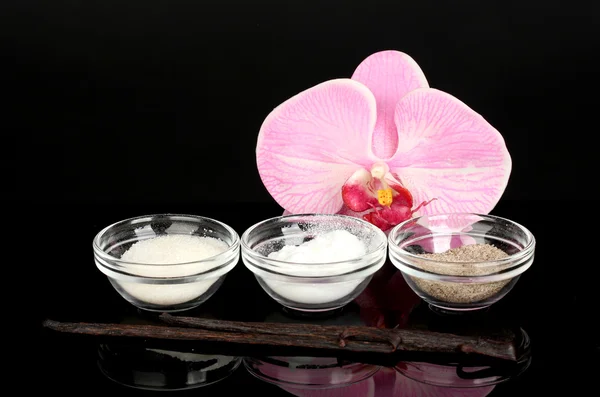 Vanilla pods, vanilla, vanilla sugar and vanilla essence isolated on black — Stock Photo, Image