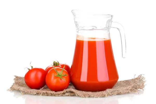 Tomato juice in pitcher on sackcloth isolated on white — Stock Photo, Image