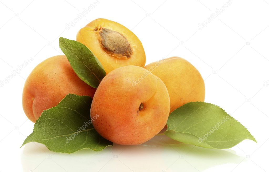 Ripe sweet apricots with green leaves isolated on white