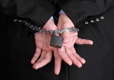 Businessman hands fettered with chain and padlock clipart