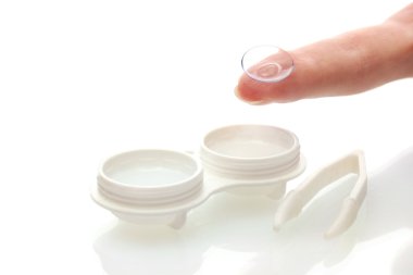 Contact lenses in containers and tweezers, isolted on white clipart