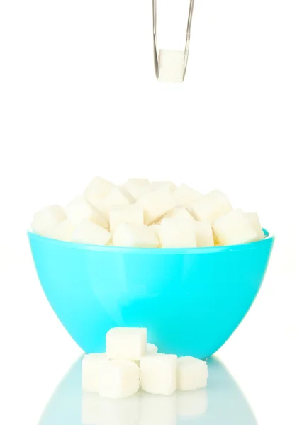 White lump sugar in bowl with sugar-tongs on white background — Stock Photo, Image