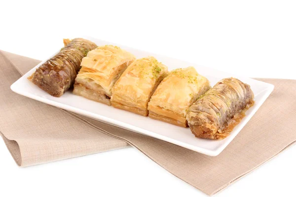 stock image Sweet baklava on plate isolated on white