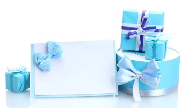 stock image Blue gifts with bows and blank postcard isolated on white