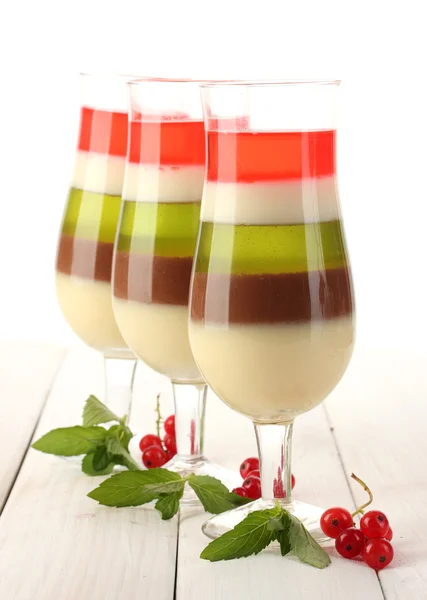 Fruit gelei in glazen, rode bessen en mint op houten tafel — Stockfoto