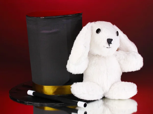 Bunny and black cylinder on red background — Stock Photo, Image