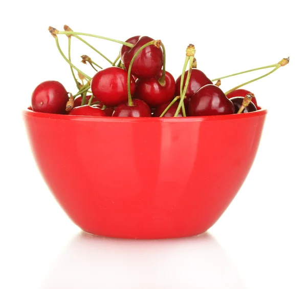 Cherry in a red bowl isolated on white — стоковое фото