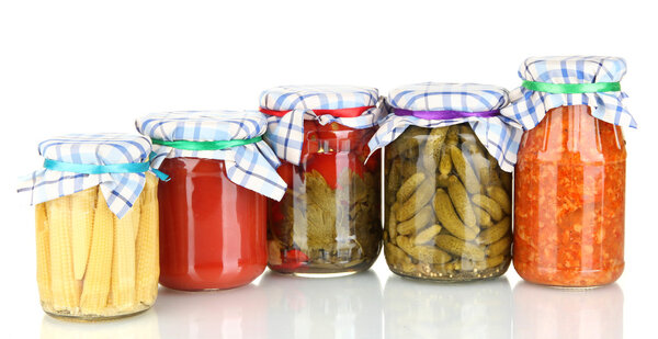 Jars with canned vegetables isolated on white