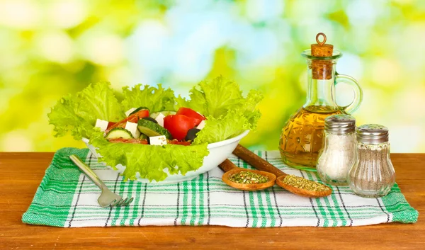 Tasty greek salad on bright green background — Stock Photo, Image