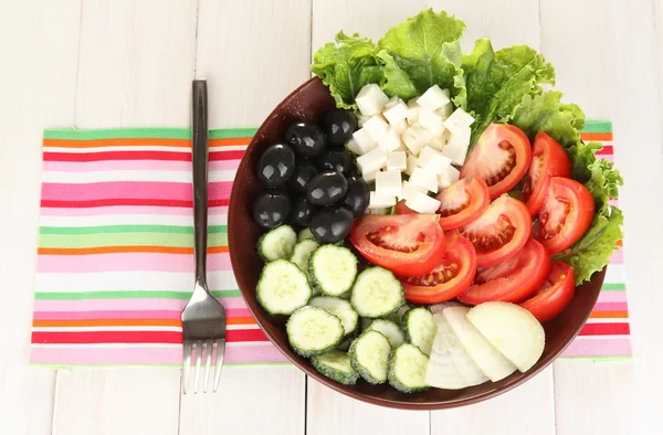 Tasty Greek salad on white wooden background — Stock Photo, Image