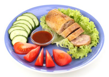 Tasty meat cutlet with garnish on plate isolated on white