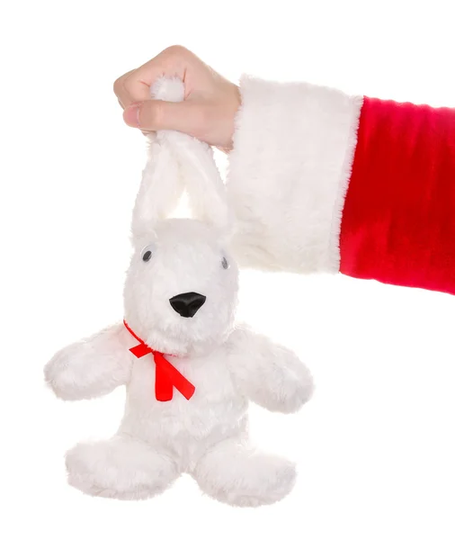 Babbo Natale mano tenendo giocattolo coniglio isolato su bianco — Foto Stock