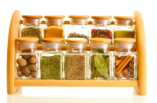 Powder spices in glass jars on wooden shelf isolated on white — Stock Photo, Image