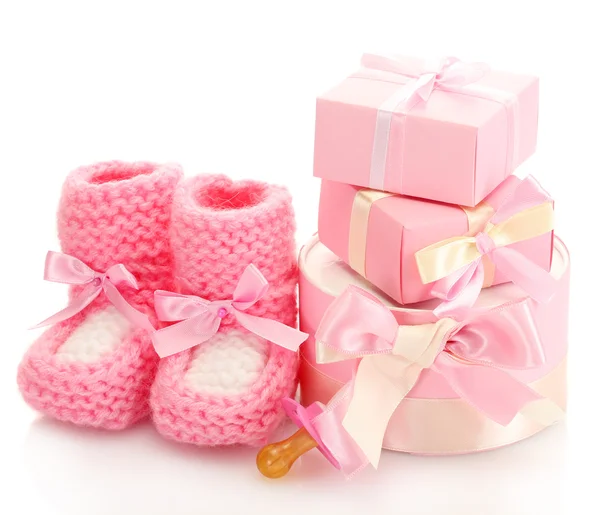 Pink baby boots, pacifier and gifts isolated on white — Stock Photo, Image