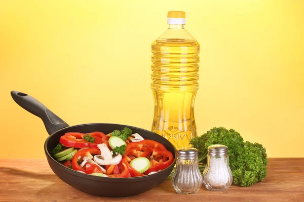 Обсмажування сковороди з овочами на жовтому фоні — стокове фото