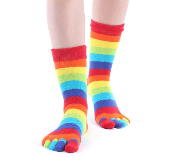 Kvinnliga ben i färgglada randiga strumpor isolerad på vit — Stockfoto