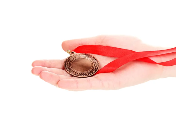 Бронзовая медаль в руке изолированы на белом — стоковое фото