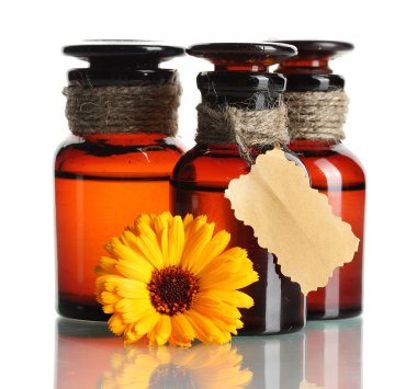 Medicine bottles and beautiful calendula flower, isolated on white clipart