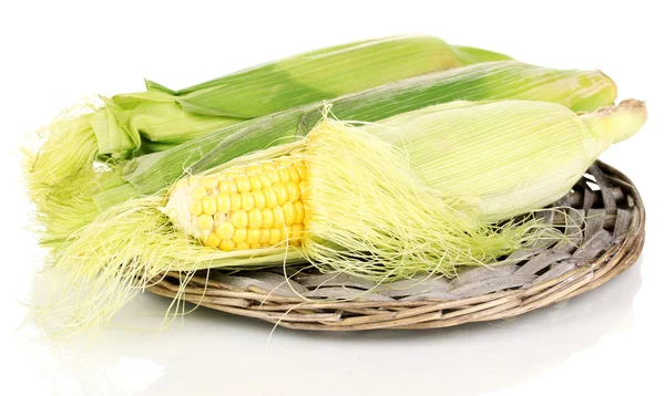 Fresh corn cob on wicker mat isolated on white — Stock Photo, Image