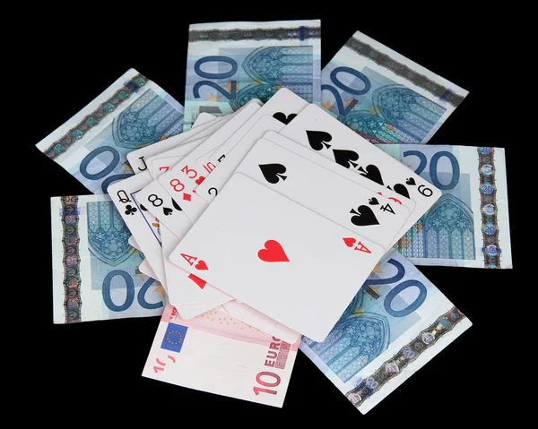 Euro and a deck of playing cards isolated on black — Stock Photo, Image