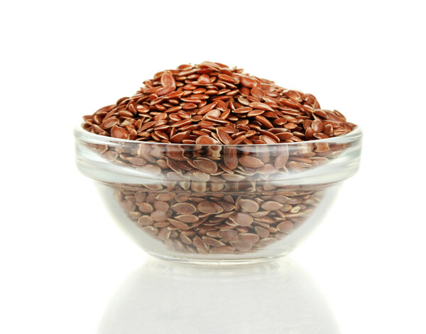 Flax seeds in glass bowl isolated on white