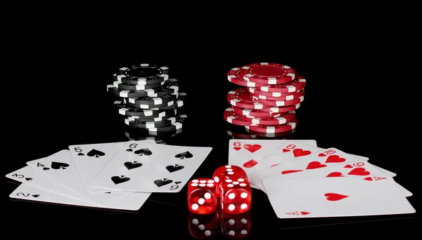 Winning combination of playing cards with poker chips and dice on black background — Stock Photo, Image