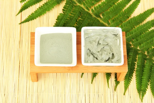 Cosmetic clay for spa treatments on straw background close-up — Stock Photo, Image