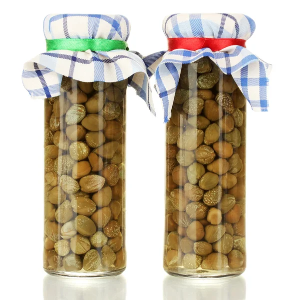 Glass jars with tinned capers isolated on white — Stock Photo, Image