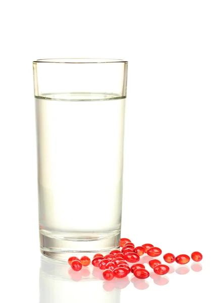 Un verre d'eau et des pilules isolées sur gros plan blanc — Photo
