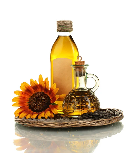 Oil in bottles, sunflower and seeds isolated on white — Stock Photo, Image