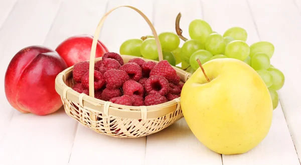 Ripe sweet fruits and berries on wooden background — Stock Photo, Image