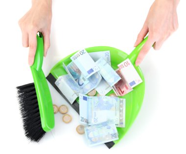 Sweeps money in the shovel on white background close-up clipart