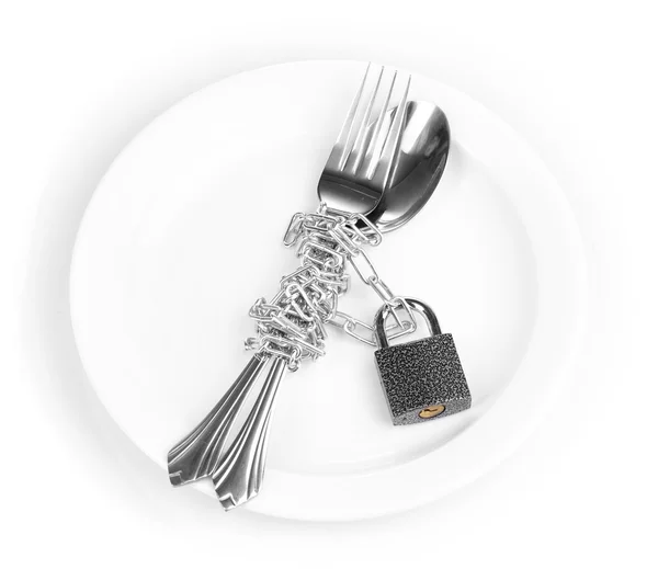 stock image Fork and spoon with chain and padlock on plate isolated on white