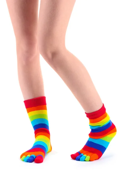 Piernas femeninas en calcetines a rayas de colores aislados en blanco —  Fotos de Stock