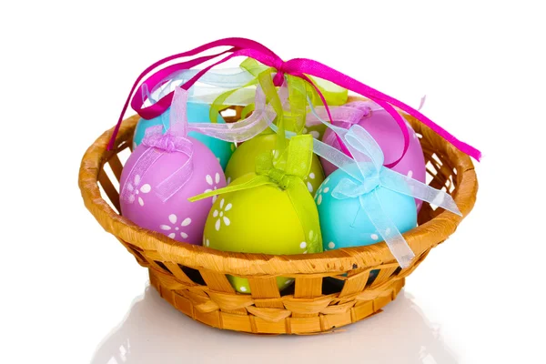 Colorful easter eggs in basket isolated on white — Stock Photo, Image