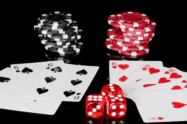 Winning combination of playing cards with poker chips and dice on black background — Stock Photo, Image