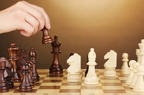 Chess board with chess pieces on brown background — Stock Photo, Image