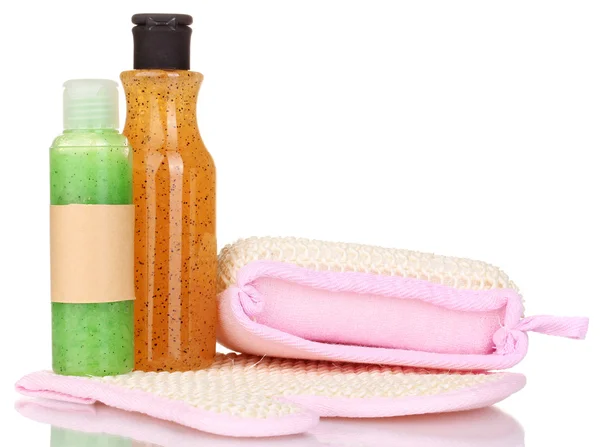 Bottles with scrub and sponges isolated on white — Stock Photo, Image
