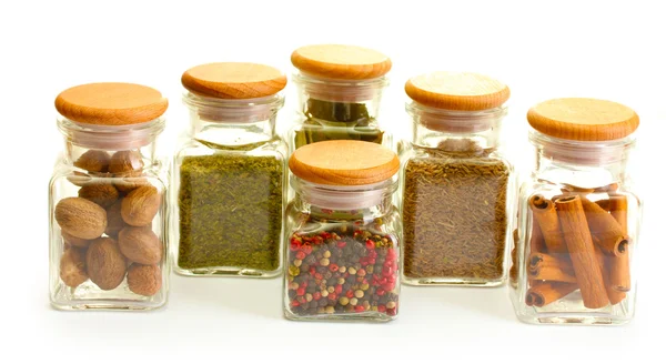 Powder spices in glass jars isolated on white — Stock Photo, Image